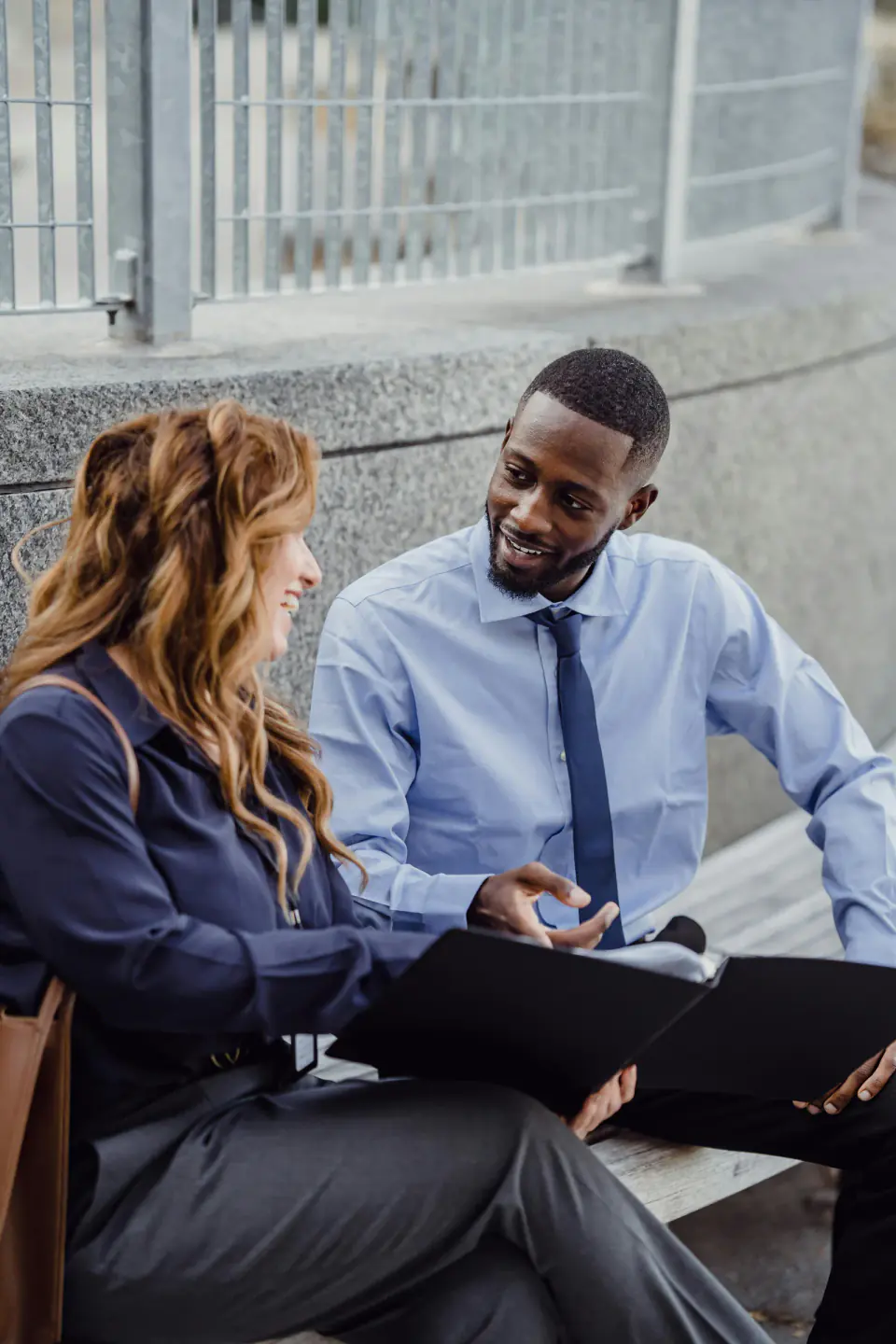 Two professionals reviewing a file in a candidate support and interview preparation setting